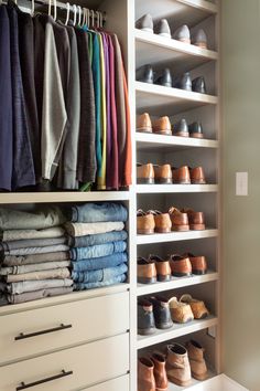 an organized closet with shoes, pants and blankets on the bottom shelf in front of it