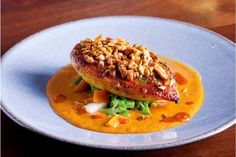 a white plate topped with food on top of a wooden table