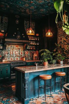 a kitchen with an island, potted plants and two stools in front of it