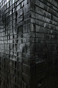 a black brick wall that is made out of wood