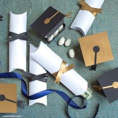 graduation caps and diplomas are laid out on top of each other with blue ribbons