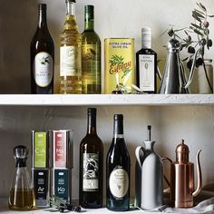 the shelf is full of different types of wine and liquor bottles, including one with a price tag on it