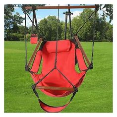 a red hanging chair in the grass