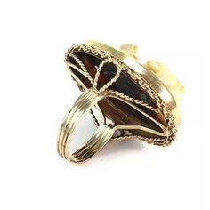 This lovely vintage ring is crafted from 14k yellow gold. It features an oval shape top with fine wire rope base around the frame. The top center has a deep carved white cameo of a woman. The frame sits on an open wire shank with grooved band.    Material: 14k yellow gold  Shell cameo  Carved Girl: 22.6mm tall x 13.6mm wide  Measurement: 1.28" long x 1.02" wide x 0.57" high  Ring Size:  6  Weight:  7.8 grams Classic Oval Cameo Rings, Oval Yellow Gold Cameo Ring, Vintage Oval Carved Jewelry, Vintage Cameo Oval Cabochon Rings, Antique Yellow Gold Cameo Ring, Gold Oval Ring, Oval Ring, Oval Rings, Vintage Ring