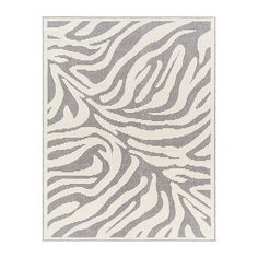 a white and gray rug with zebra print