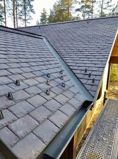 the roof of a house with some metal studs on it's shingles