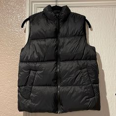 Brand New Trendy Black Puffer Vest, Black Puffer Vest For Spring, Black Winter Vest With Pockets, Black Puffer Vest For Winter, Black Winter Vest For Cold Weather, Urban Black Vest For Fall, Black Vest For Cold Weather And Winter, Casual Black Winter Vest, Trendy Black Vest With Pockets