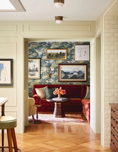 a living room filled with furniture and pictures on the wall