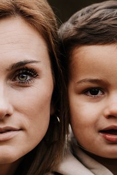 a woman and child are looking at the camera with an intense look on their faces