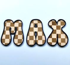 the letters are made out of wood and have checkered designs