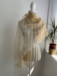 Beautiful 20's style sheer ivory and gold beaded scarf with gorgeous seed bead and sequin floral embellishment and fringes at the bottom. This lovely elegant fringed shawl wrap is perfect for an evening party outfit or as a part of your wedding guest outfit. This embellished sheer shawl has gorgeous shine when exposed to light due to the silk fabric and metalised yarn. Beautiful seed bead beadwork for a perfect vintage look. Era: 00s Condition: there are a few pulled threads or perhhals the natu Elegant Cream Dupatta With Pearl Embroidery, Gold Dupatta With Pearl Embroidery, Traditional Gold Dupatta With Pearl Embroidery, Cream Dupatta With Pearl Embroidery In Traditional Drape, Traditional Festive Sheer Dupatta, White Wedding Scarves For Festive Season, Traditional Sheer Dupatta For Festive Occasions, Elegant Cream Organza Dupatta, Elegant Cream Scarves For Festive Season