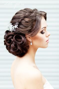 a woman wearing a wedding hair comb with flowers in her hair