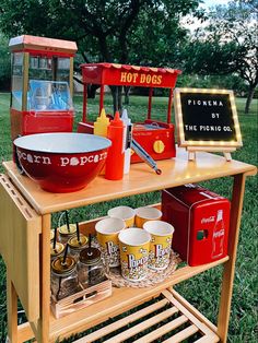 an old fashioned hot dog stand with food on it's shelf and other items