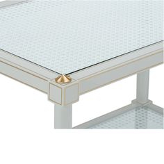 a white and gold coffee table with glass top