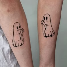 two people with tattoos on their legs, one has a ghost and the other has a ghost