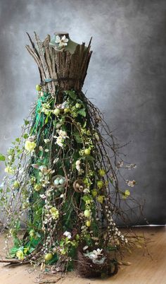 a dress made out of branches and flowers