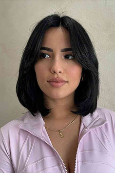 Sophisticated woman with a longer bob and middle-parted bangs Lived In Bob Haircuts, Haircuts In Style, Lob Haircut Black Hair, Short Hair Above Shoulder Straight, Black Bob With Curtain Bangs, Trendy Bob Hairstyles Thick Hair, Short Hairstyle Middle Part, Layered Bob Middle Part, Middle Part Bob With Layers