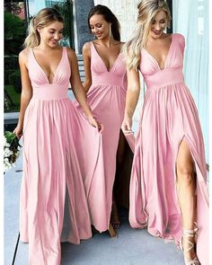 three women in pink dresses standing next to each other and one is holding her leg