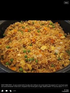 a pan filled with rice, peas and carrots