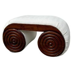 a wooden bench with white cushions on it