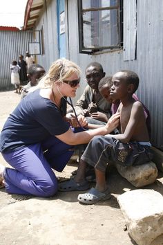 a woman is helping children with their health