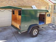 a small trailer parked in front of a house