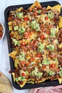 an enchilada casserole in a baking dish with tortilla shells