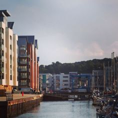 boats are docked in the water next to buildings