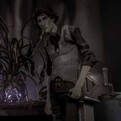 a man standing next to a plant in a dark room