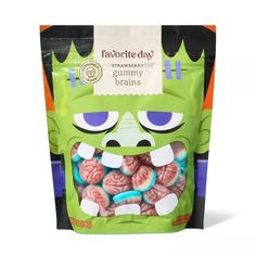 a green bag filled with gummy bears and an angry monster face on the front