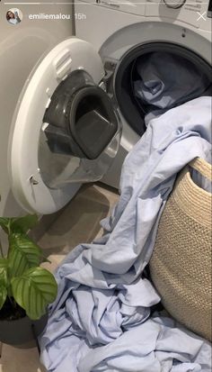 a pile of clothes sitting next to a washing machine