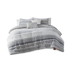 a bed with grey and white striped comforter