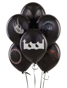 a bunch of black balloons with white letters and pictures on them, all in the same shape