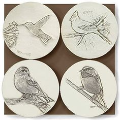 four bird coasters with birds on them