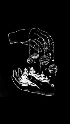 two hands holding ornaments in the dark, one is lit up and the other is drawn