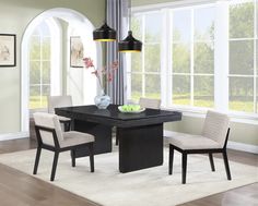 a dining room table with four chairs around it