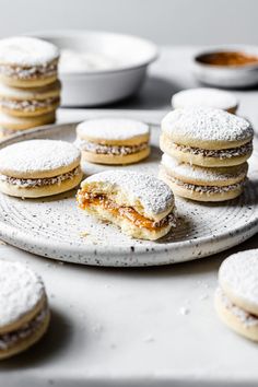 powdered sugar covered cookies are on a plate