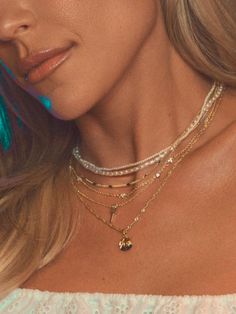 Dainty, shimmery, and perfect for layering. The In Bloom Dainty Chain Necklace really is perfect. Coming in gold and silver, this dainty necklace adds a touch of shine to your look with mini gemstone embellishments. While this can be worn on its own for a simple, everyday look, it’s also the perfect layering necklace. Pair this silver or gold necklace with your other favorite necklaces for a full stack. Brightening Skincare, Uncommon James, Dainty Chain Necklace, Dainty Chain, Layered Jewelry, Engraved Jewelry, Layering Necklace, Beauty Items, Dainty Necklace