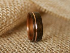 a wedding band with two different wood inlays on top of burlock fabric