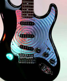 a black electric guitar with an abstract design on it