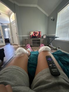 a person with bandages on their legs watching tv