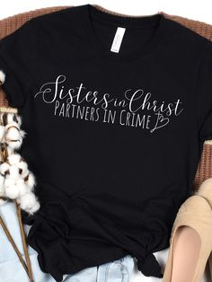 "Sisters in Christ Partners in Crime Short Sleeve T-Shirt Proverbs 18:24 says, \"One who has unreliable friends soon comes to ruin, but there is a friend who sticks closer than a brother\" This design is for best friends who stick together through whatever may come. Show your bestie how much you love her when you wear this adorable T-shirt!  Unisex Fit, Ultra Soft Bella + Canvas, Free Shipping, Christian Shirts This classic unisex jersey short sleeve tee fits like a well-loved favorite. Soft cotton and quality print make users fall in love with it over and over again. These t-shirts have-ribbed knit collars to bolster shaping. The shoulders have taping for better fit over time. Dual side seams hold the garment's shape for longer.  100% Airlume combed and ringspun cotton (fiber content may Bible Verse Tees, Faith Shirt, Religious Gifts, Christian Clothing, Christian Shirts, Jersey Shorts, Bible Verse, Bella Canvas, Best Friend