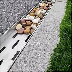 rocks are placed on the edge of a metal gutter cover to protect them from falling