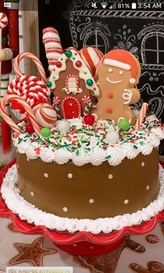 there is a large cake decorated with gingerbreads and candy canes