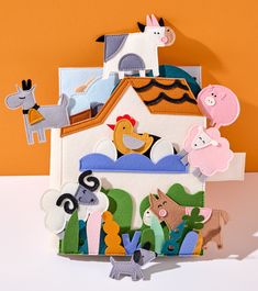 a house made out of felt with farm animals on it