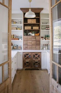 a kitchen with wooden cabinets and white walls