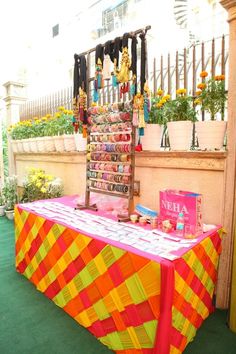 a table that has some items on it and is set up in front of a fence