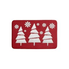 a red door mat with white snowflakes on it and trees in the middle