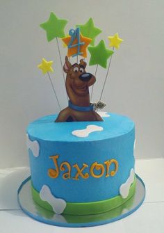 a birthday cake with a dog on top and stars in the sky around it that says ajaxon