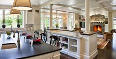 a large kitchen with an island, stove and dining room table in the center area